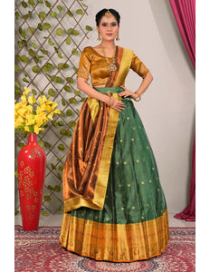 Woman wearing a traditional green and gold lehenga choli with dupatta