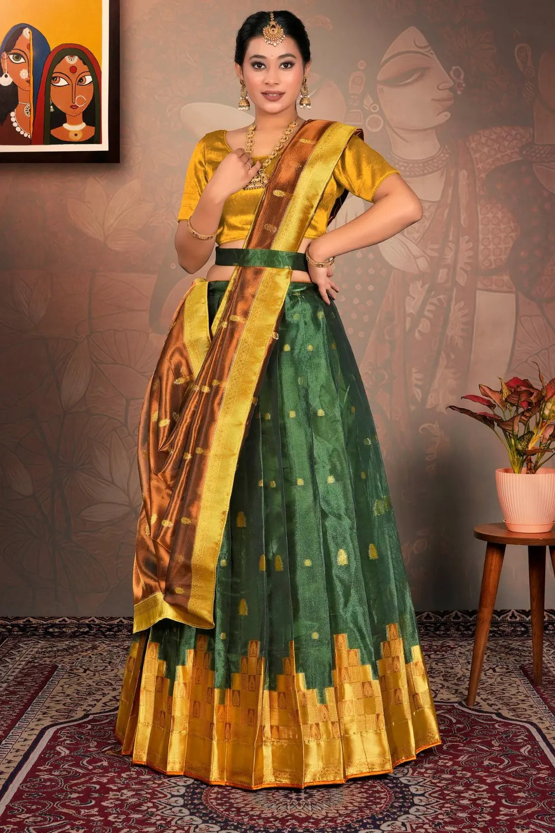 Woman in a green and gold traditional lehenga choli with dupatta