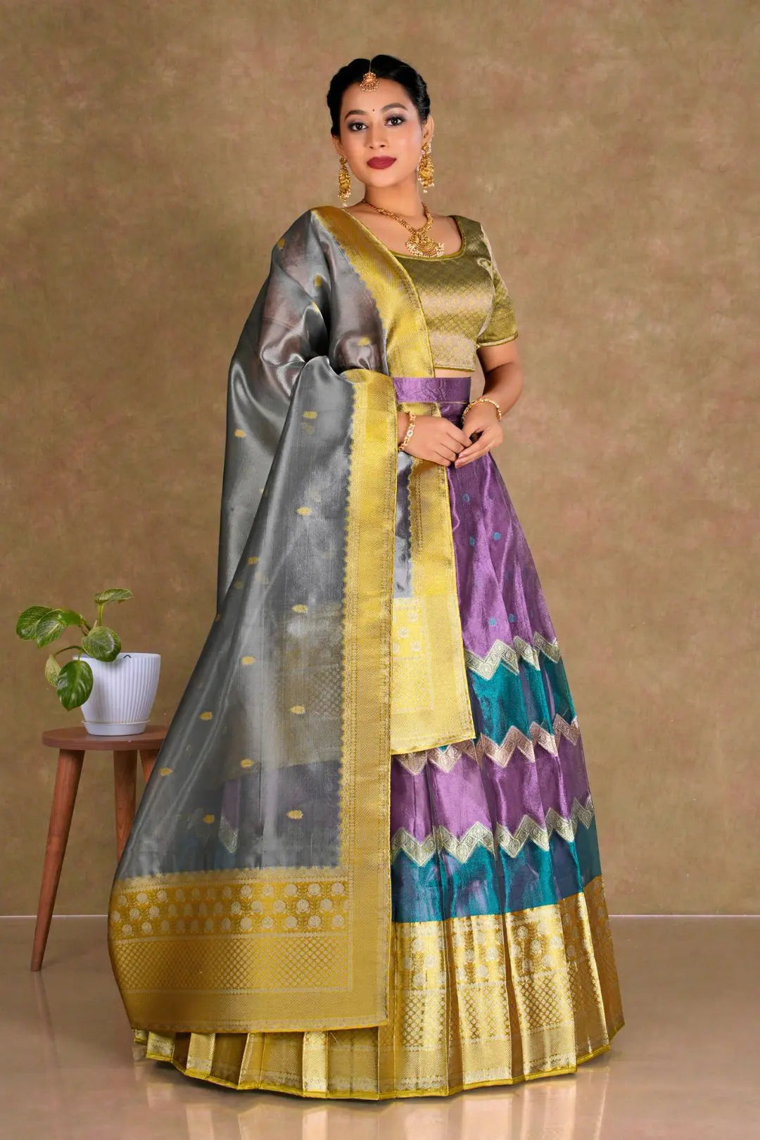 Woman wearing a traditional half saree with a multicolor design