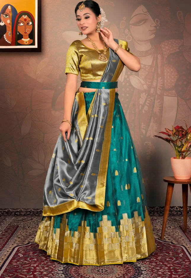 Woman in a traditional outfit with gold, green, and gray colors