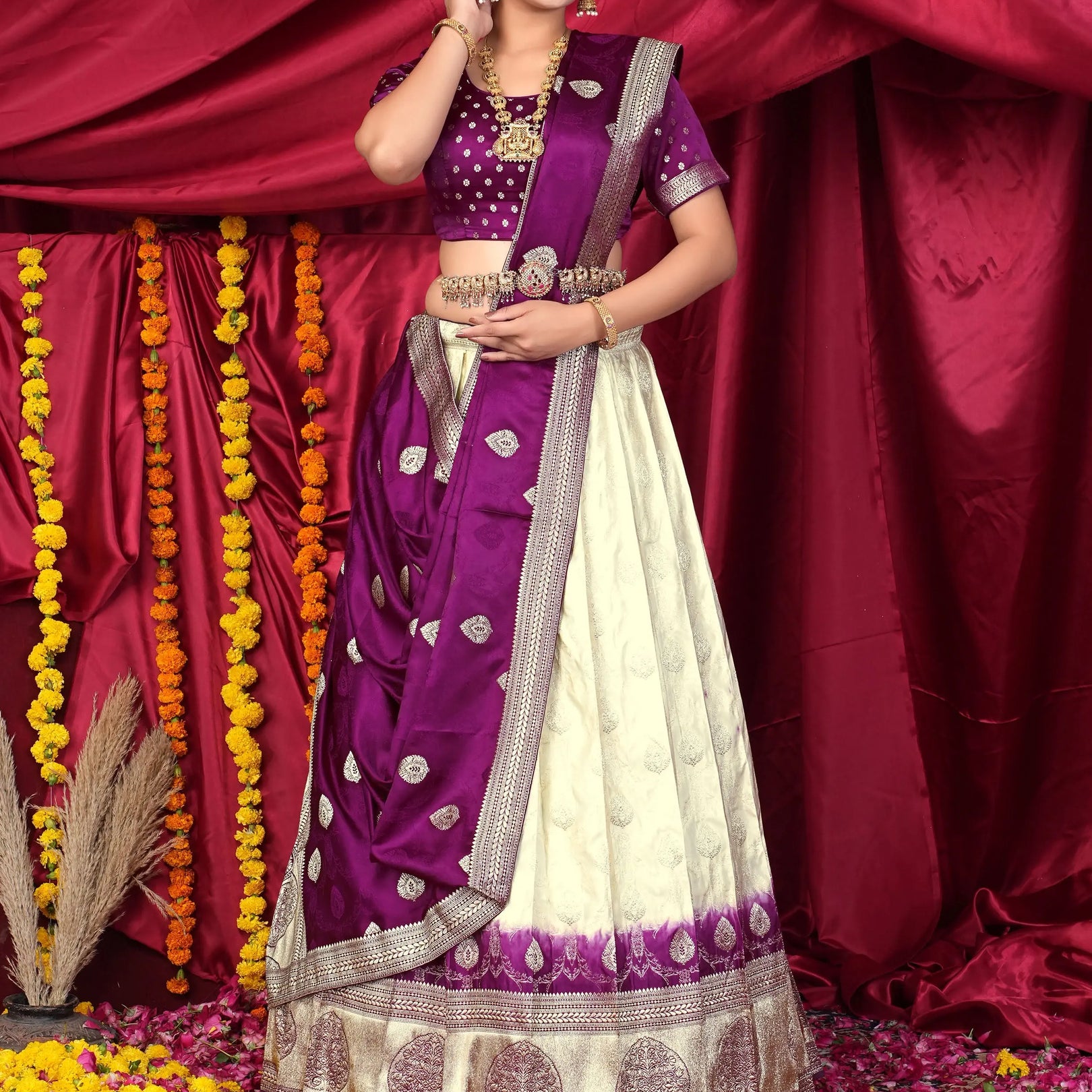 Woman in a traditional purple and white lehenga choli