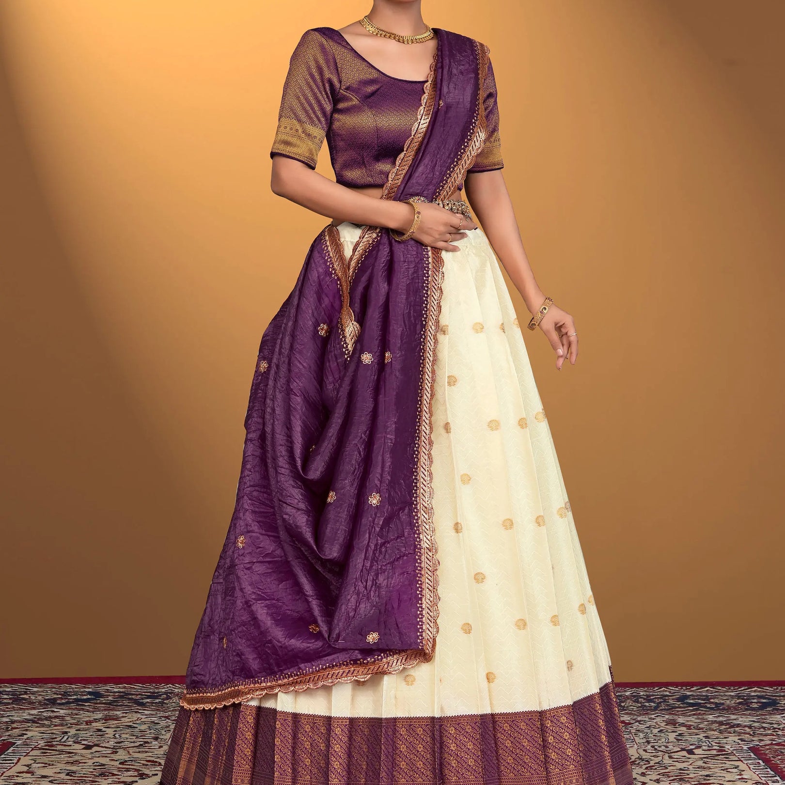 Woman wearing a traditional purple and white lehenga choli