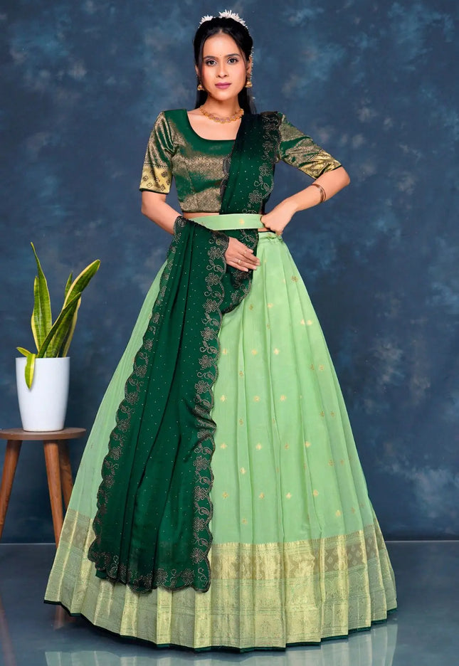 Woman wearing a green and light green traditional lehenga choli with dupatta