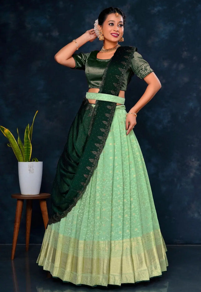 Woman in a green and light green traditional lehenga choli with dupatta