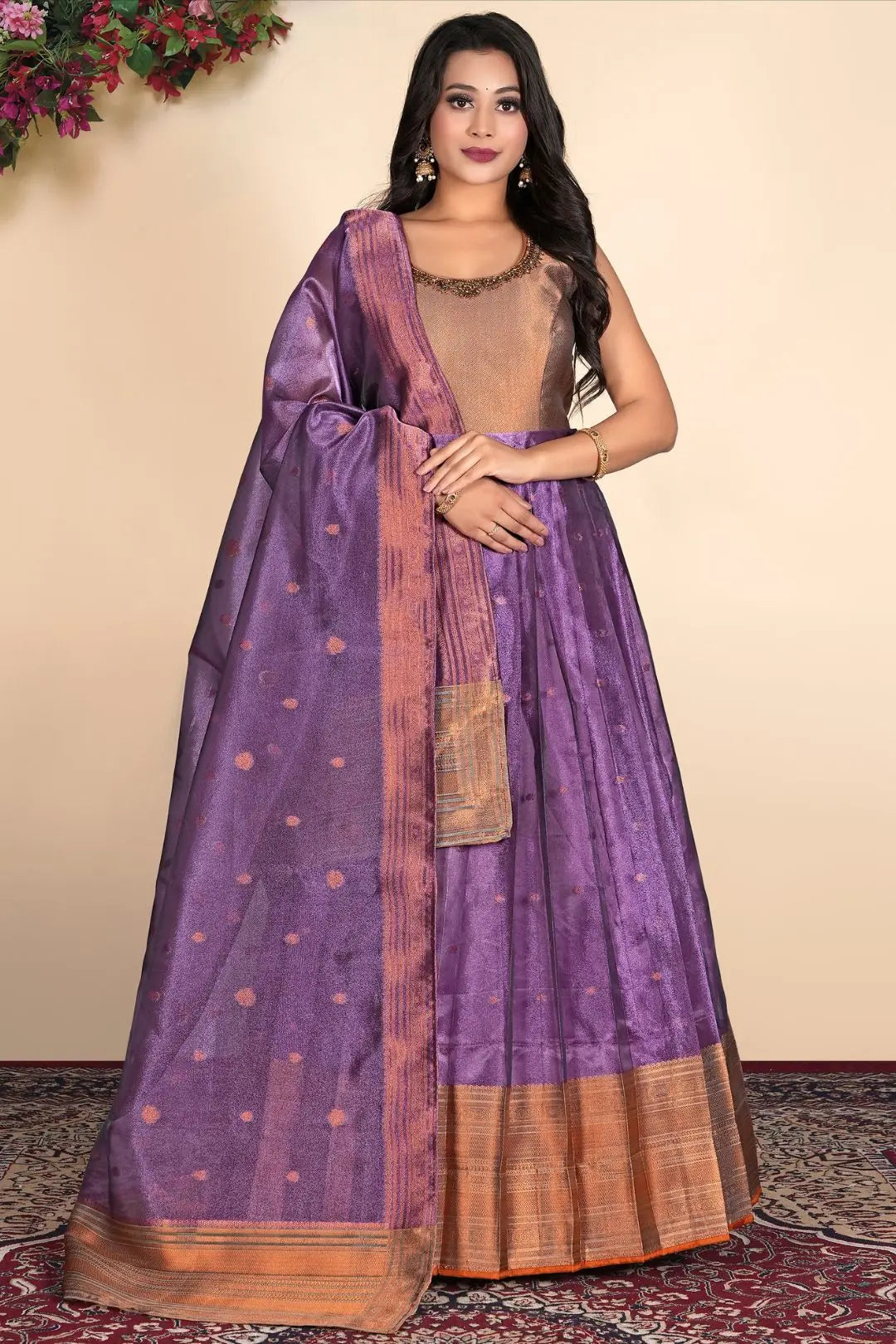 Woman wearing a traditional purple gown with a gold border