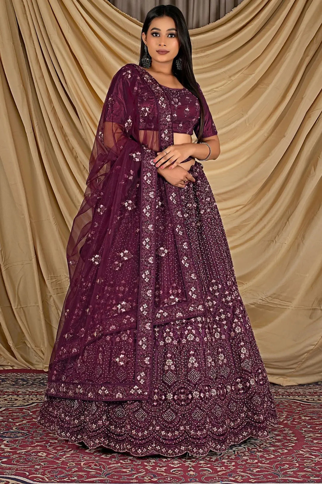 Woman wearing a purple embroidered lehenga choli with dupatta