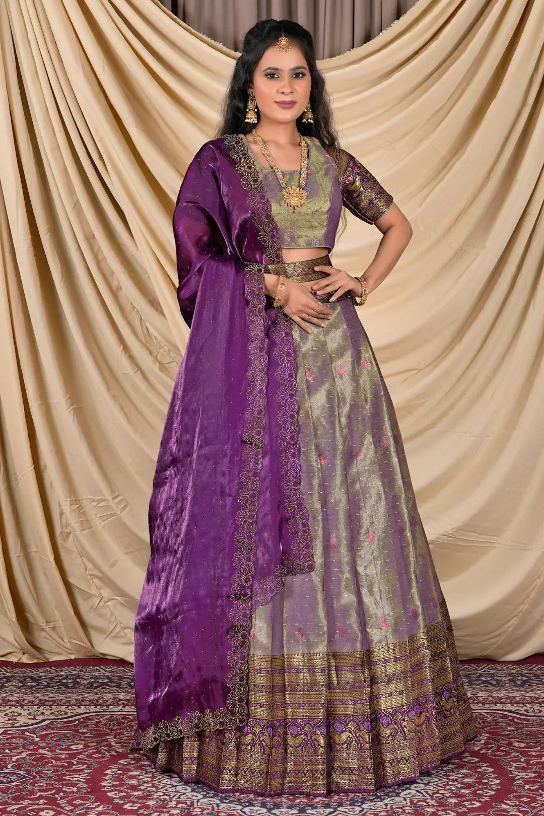 Woman wearing a traditional outfit with a purple dupatta