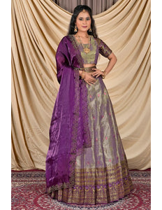 Woman wearing a traditional outfit with a purple dupatta