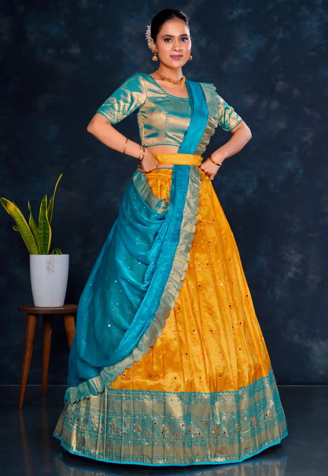 Woman wearing a traditional outfit with a blue and gold Half Saree