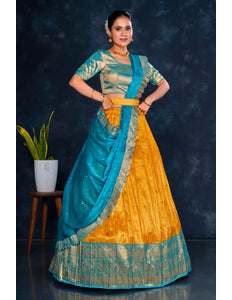 Woman wearing a traditional outfit with a blue and gold Half Saree