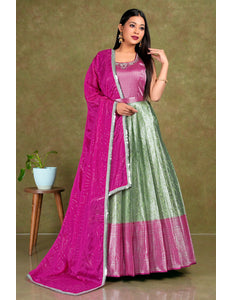 Woman wearing a pink and green traditional outfit with a matching dupatta