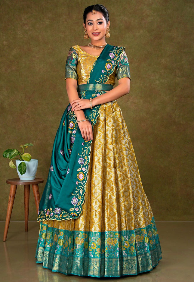 Woman wearing a traditional green and gold lehenga with a matching blouse