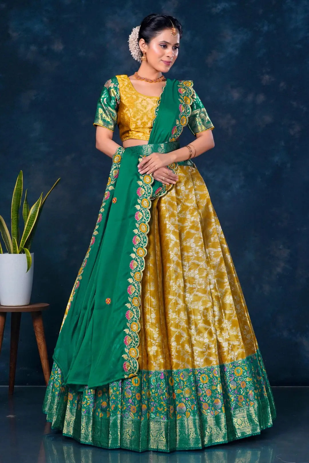 Woman wearing a green and yellow traditional outfit with floral patterns
