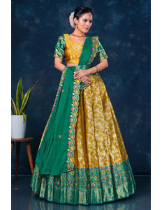 Woman wearing a green and yellow traditional outfit with floral patterns