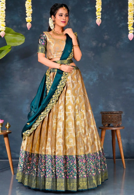 Woman in a traditional gold and green lehenga choli with dupatta