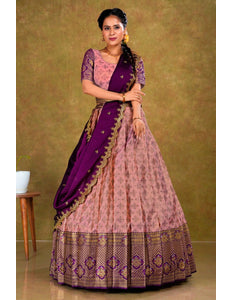 Woman wearing a traditional pink and purple lehenga with a gold border