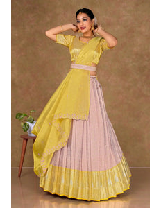 Woman wearing a yellow and pink traditional lehenga choli with dupatta