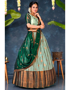 Woman in a traditional green and brown pista lehenga choli with dupatta