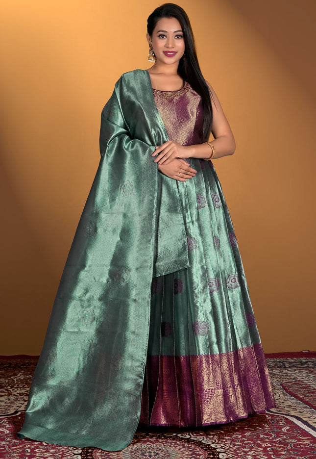 Woman wearing a green and purple gown with dupatta