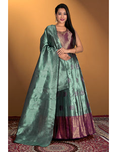 Woman wearing a green and purple gown with dupatta