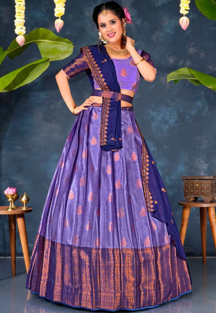 Woman in a traditional purple and blue lehenga choli with dupatta