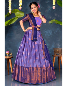 Woman in a traditional purple and blue lehenga choli with dupatta