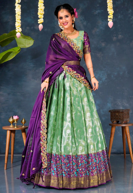 Woman in a green and purple traditional lehenga choli with dupatta