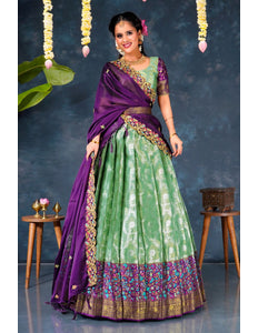 Woman in a green and purple traditional lehenga choli with dupatta