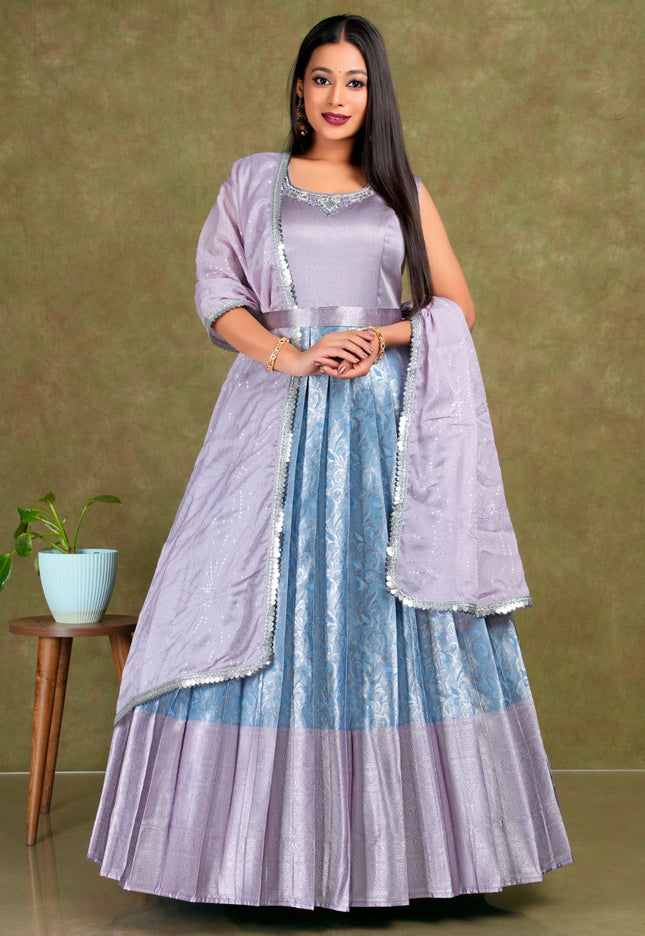 Woman wearing a light purple and blue traditional outfit with a matching dupatta