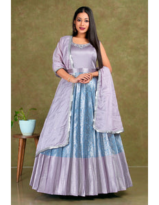 Woman wearing a light purple and blue traditional outfit with a matching dupatta