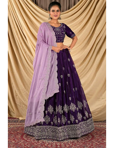 Woman wearing a purple traditional outfit with a light purple dupatta