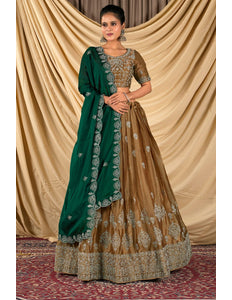 Woman wearing a green and brown traditional outfit with a gold blouse