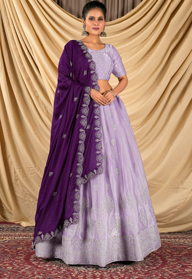 Woman wearing a purple lehenga choli with dupatta