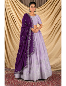 Woman wearing a purple lehenga choli with dupatta