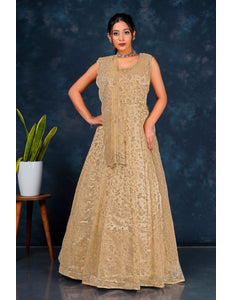 Woman wearing a beige embroidered dress Net Gown For Women