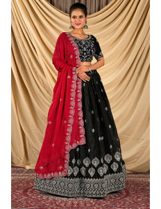 Woman wearing a black and red traditional lehenga choli and dupatta