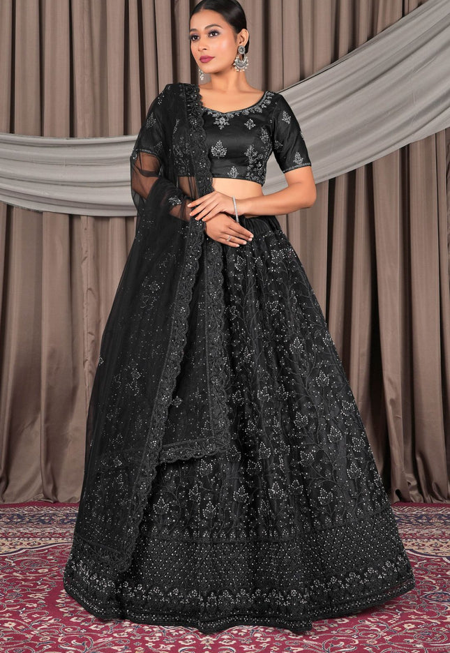 Woman wearing a black embroidered traditional lehenga choli with dupatta