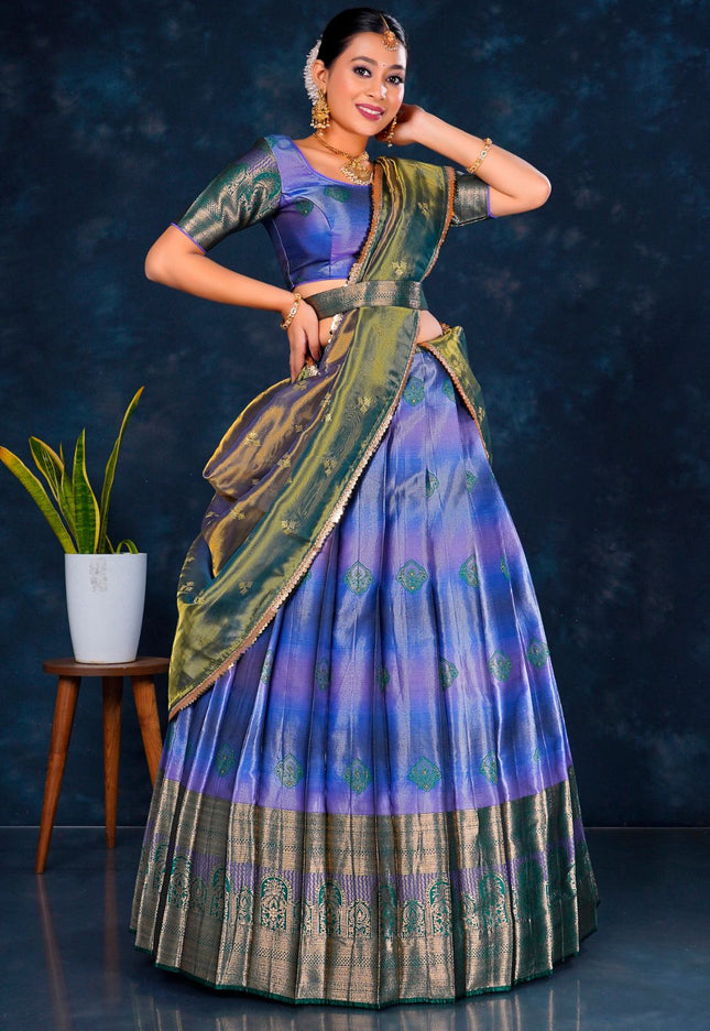 Woman in a traditional blue and green lehenga choli with dupatta
