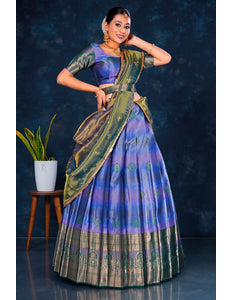Woman in a traditional blue and green lehenga choli with dupatta