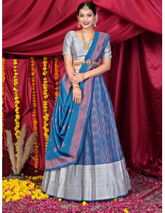 Woman wearing a blue and gray lehenga choli