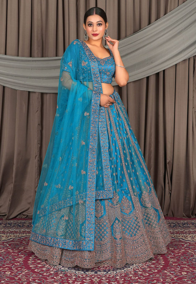 Woman in a blue embroidered traditional outfit standing