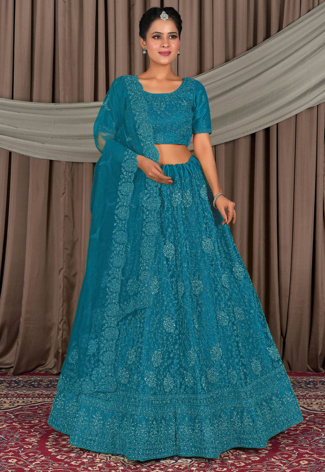 Woman wearing a teal embroidered outfit