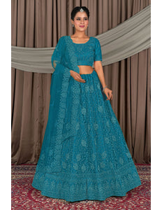 Woman wearing a teal embroidered outfit