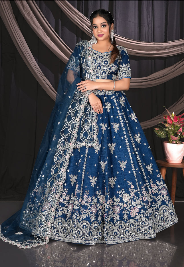 Woman wearing a blue embroidered traditional outfit