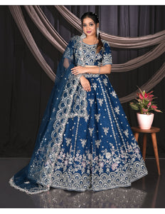 Woman wearing a blue embroidered traditional outfit