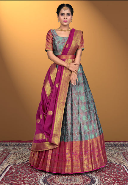 Woman wearing a traditional lehenga choli with a pink border