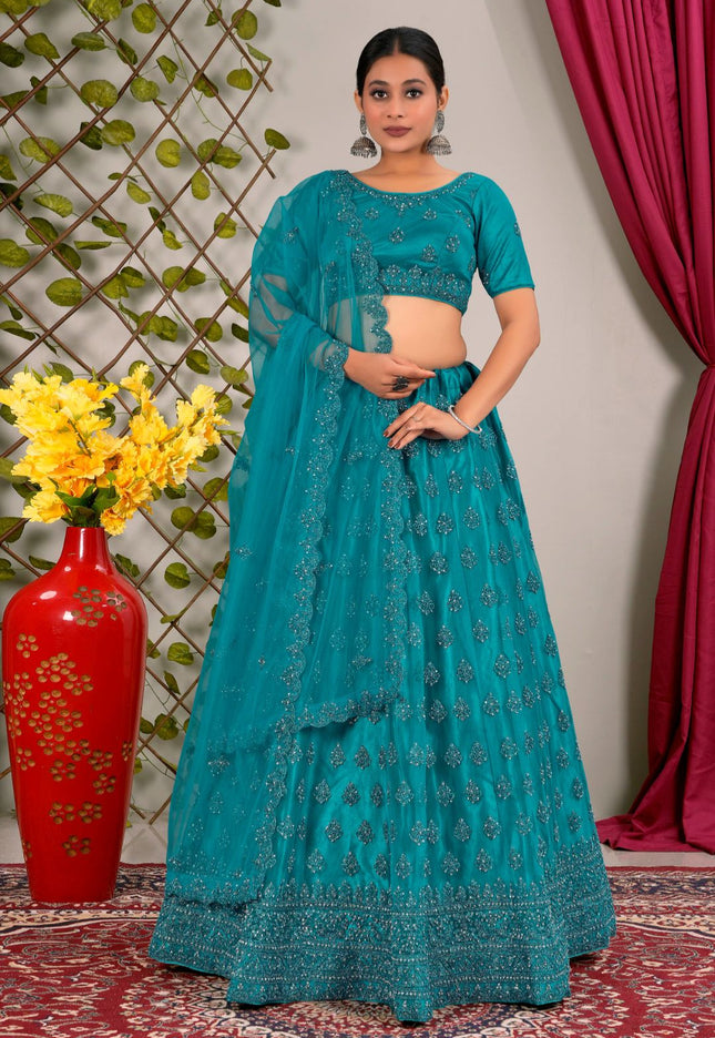 Woman in a teal traditional lehenga choli with matching dupatta