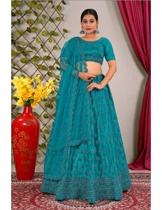 Woman in a teal traditional lehenga choli with matching dupatta