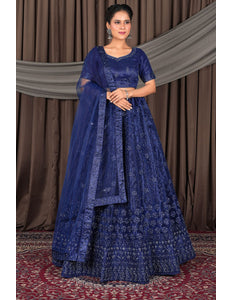 Woman wearing a traditional blue embroidered outfit with a dupatta