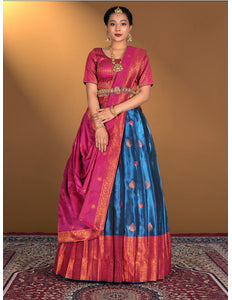 Woman wearing a traditional lehenga choli with a pink and blue design
